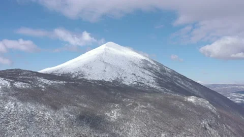 Clouds passing above the snowed Rtanj mountain 4K drone video Stock Footage 105291540