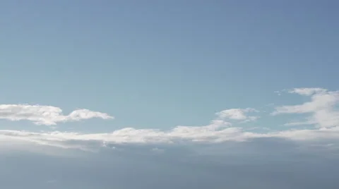 Clouds passing by against a blue sky backdrop Stock Footage 53240812