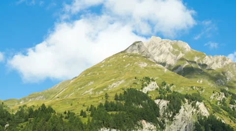 Clouds passing alpine mountain Видео 65028403