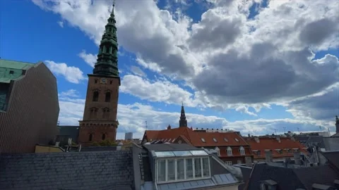 Clouds passing by Copenhagen clock tower and city roorftops Stock Footage 158990424