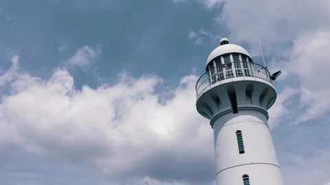 Clouds passing by lighthouse  Stock Footage 104691498