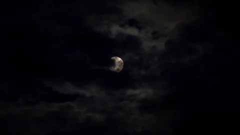 Clouds passing by moon at night. Full moon at night with cloud real time Stock Footage