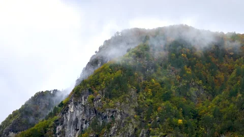 Clouds passing over an autumn colored mountain ridge Video stock 255273994