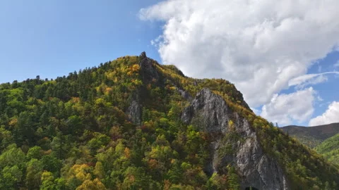 Clouds passing over colorful mountain peak timelapse Stock Footage 318869973
