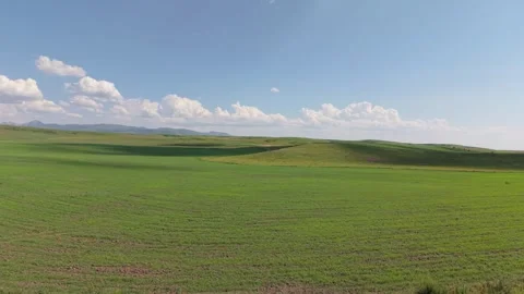 Clouds passing over green hills and fields Video stock 312441864