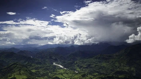 Clouds passing over green mountain Stock Footage 74974817