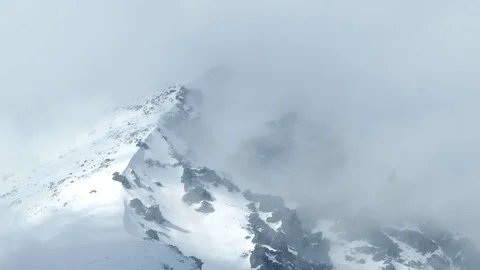 Clouds passing over high mountains covered with snow. Stock Footage 88353901