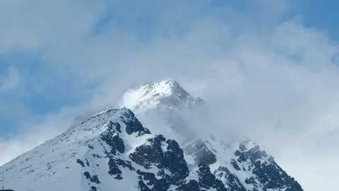 Clouds passing over high mountains covered with snow. Stock Footage 88354523