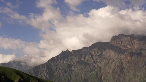 Clouds passing over Kazbegi mountains in Georgia - timelapse video Stock Footage 250601664
