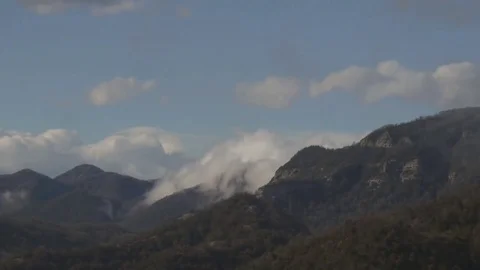 Clouds passing over a mountain 動画素材 73925777