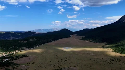 Clouds passing over mountain valley with lake Stock Footage 283316035