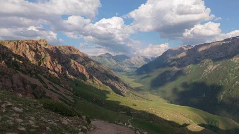 Clouds passing over mountain valley with hiking trail Video stock 312449977