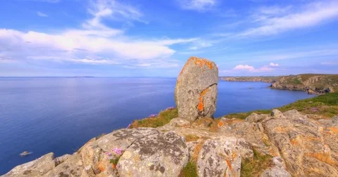 Clouds passing over rocks and ocean, 4K HDR motion time lapse Stock Footage 76914431
