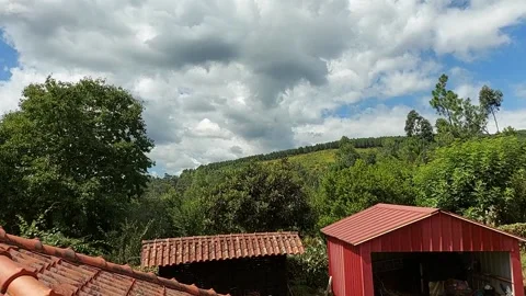 Clouds passing over roofs Video stock 206795645