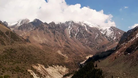 Clouds passing over snow capped mountains in Ala Archa National Park, kyrgyzstan Stock Footage 288573718