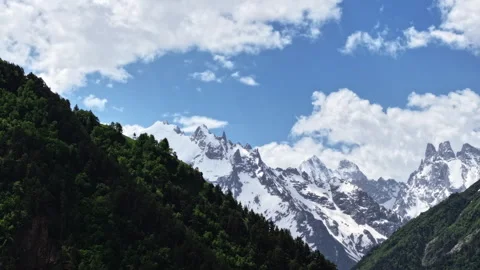 Clouds passing over snow capped caucasus mountains timelapse Stock Footage 318868701