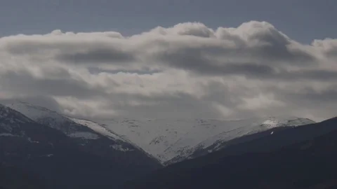 Clouds passing over snowy mountains 動画素材 73925746