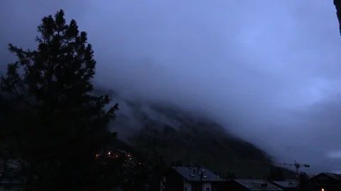 Clouds passing over the swiss Alps at sunrise Stock Footage 114823342