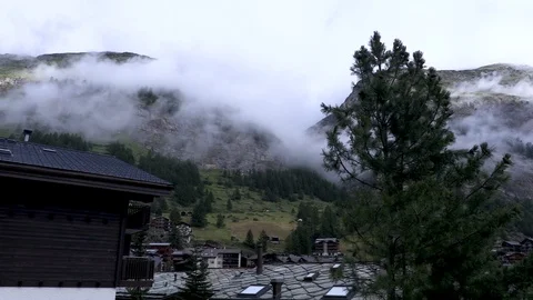 Clouds passing over the swiss Alps at sunrise Stock Footage 114823424
