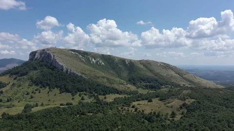 Clouds passing over the valley and the top of Stol mountain 4K drone video Stock Footage 121625078