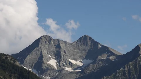 Clouds passing quickly over the mountain peaks Stock Footage 296055632