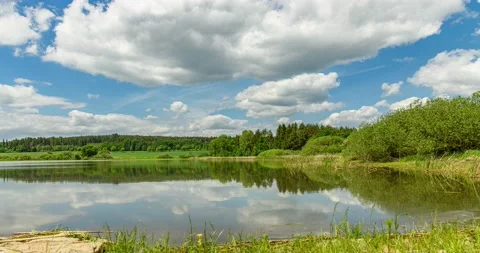 Clouds passing on sky over a lake Stock Footage 195323714