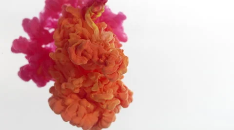 Clouds of pink and orange ink expand in clear liquid, mixing together. Stock Footage 64893412