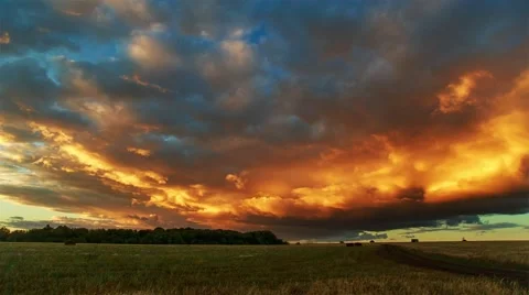 Clouds portend rain forest over the field. Stock Footage 53746829