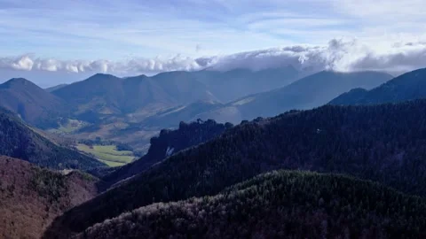 Clouds pour over the mountain ridge.Landscape in the national park at the end of 스톡 동영상 221710626