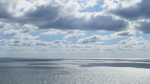 Clouds quickly fly over the sea and cast beautiful shadows. Timelapse footage Stock Footage 97400916