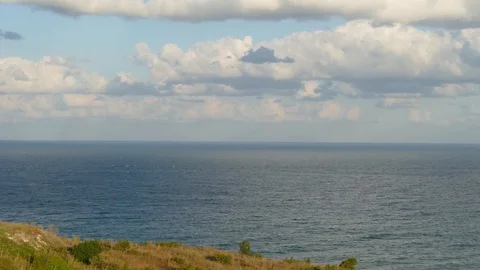 Clouds quickly fly over the sea and cast beautiful shadows. Timelapse footage Stock Footage 97589431