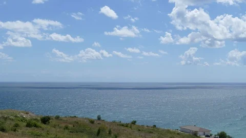 Clouds quickly fly over the sea and cast beautiful shadows. Timelapse footage Stock Footage 97589777