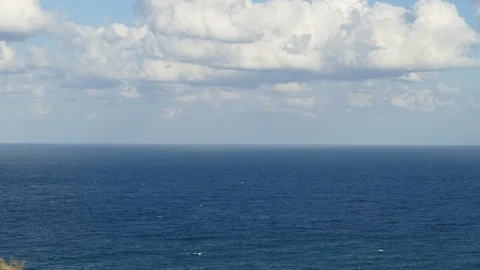 Clouds quickly fly over the sea and cast beautiful shadows. Timelapse footage Stock Footage 97603916