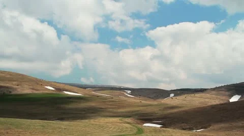 Clouds race over a mountain valley Stock Footage 21272210