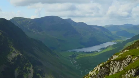 Clouds racing above mountaintop of High Stile as shadows rapidly move Stock Footage 278450392