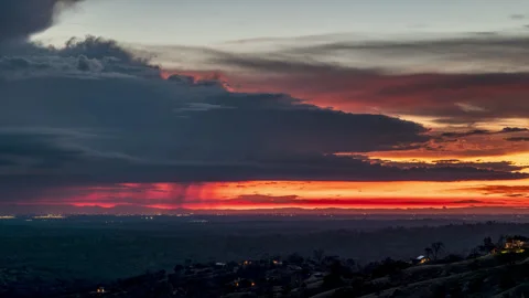 Clouds Rain and City Lights in a Sunset Timelapse Stock Footage 278316400