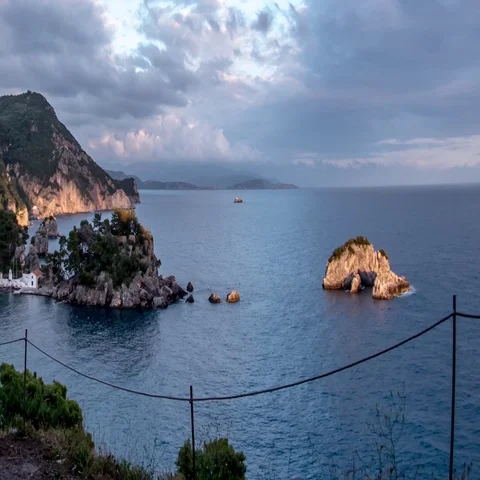 Clouds of rain running over the rocks that are broken waves of the sea Stock Footage 69323243
