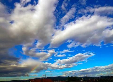 Clouds with rainbow Stock Photos