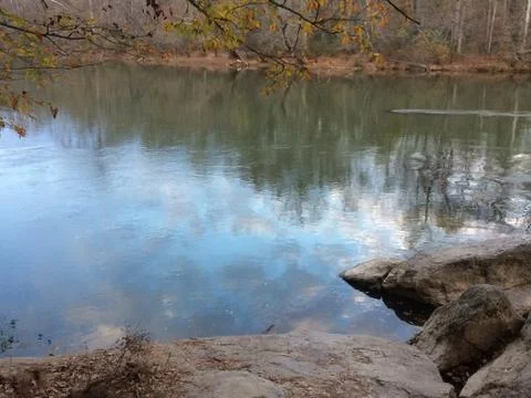Clouds reflect in river Stock Photos