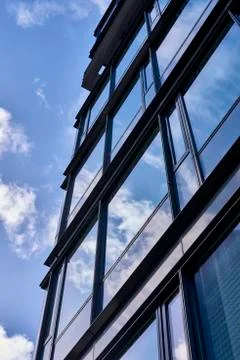 Clouds reflected in buildings Stock Photos