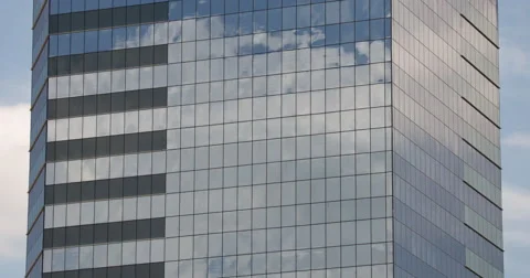 The clouds reflected in glass skyscraper Stock Footage 64455667
