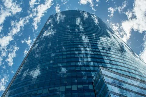 Clouds reflected on the glass surface of the building Stock Photos