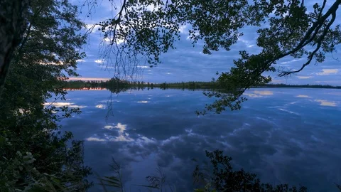 Clouds reflected in the lake at sunrise. Stock Footage 97352523