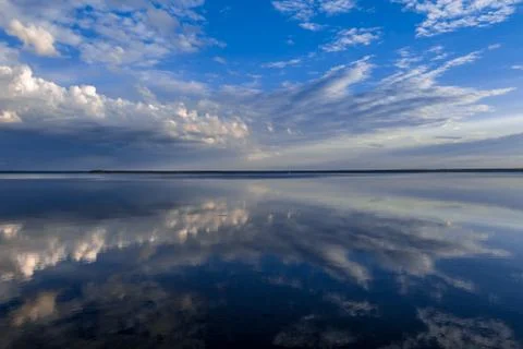 Clouds reflected in the mirror of the lake Stock Photos