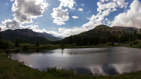 Clouds reflected in mountain pond with wildfire smoke timelapse Stock-Footage 154946412