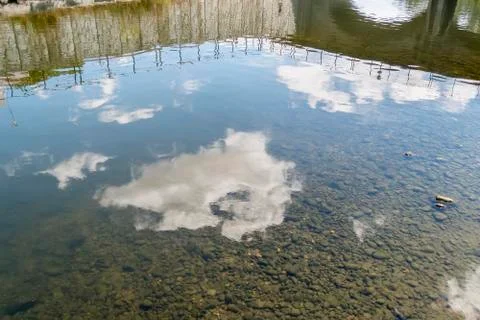 Clouds reflected in the river water Stock Photos
