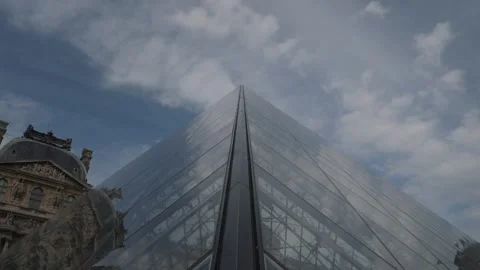 Clouds reflected by sides of pyramid at entrance to Louvre Stock Footage 151784822