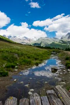 Clouds reflected in a small river (Vertical) Фото