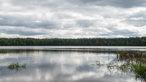 Clouds reflected in the smooth water of the lake. 動画素材 115204825