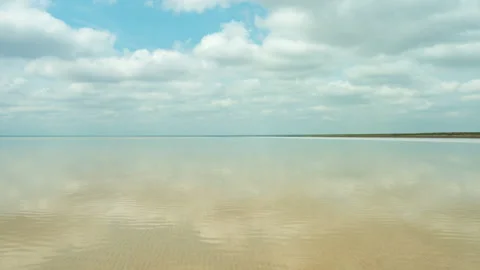 Clouds reflected in the smooth water of the lake. Stock Footage 168398606